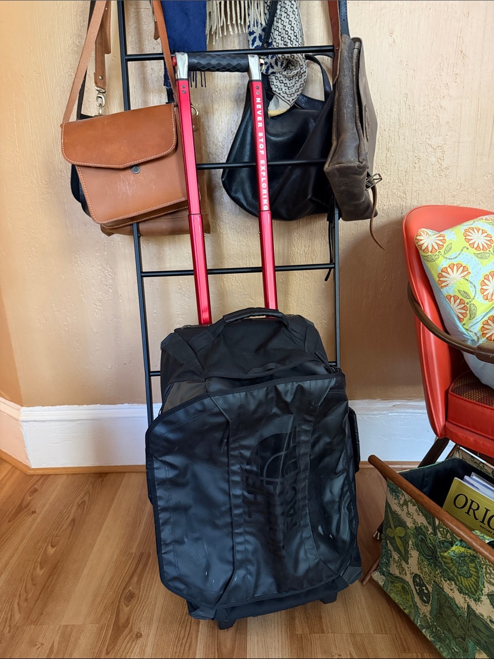 The North Face Black Rolling Travel Bag with Red Telescoping Handle